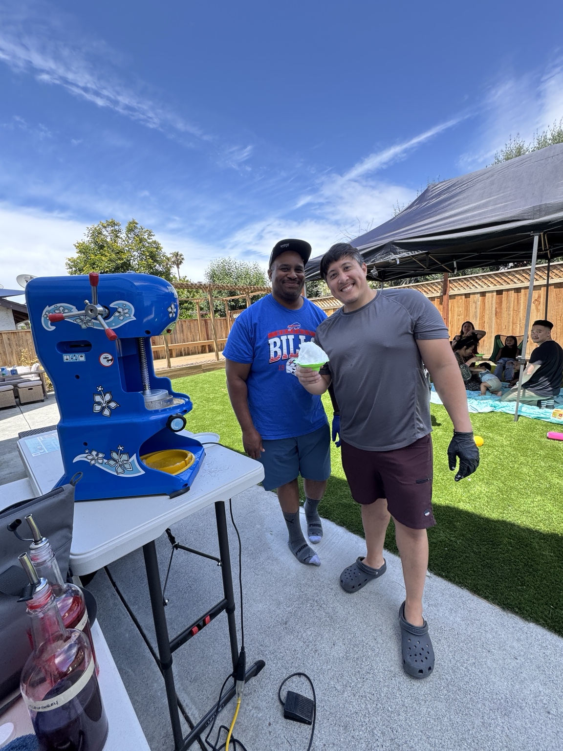 Guest holding finished shaved ice at a Friends & Cubs event